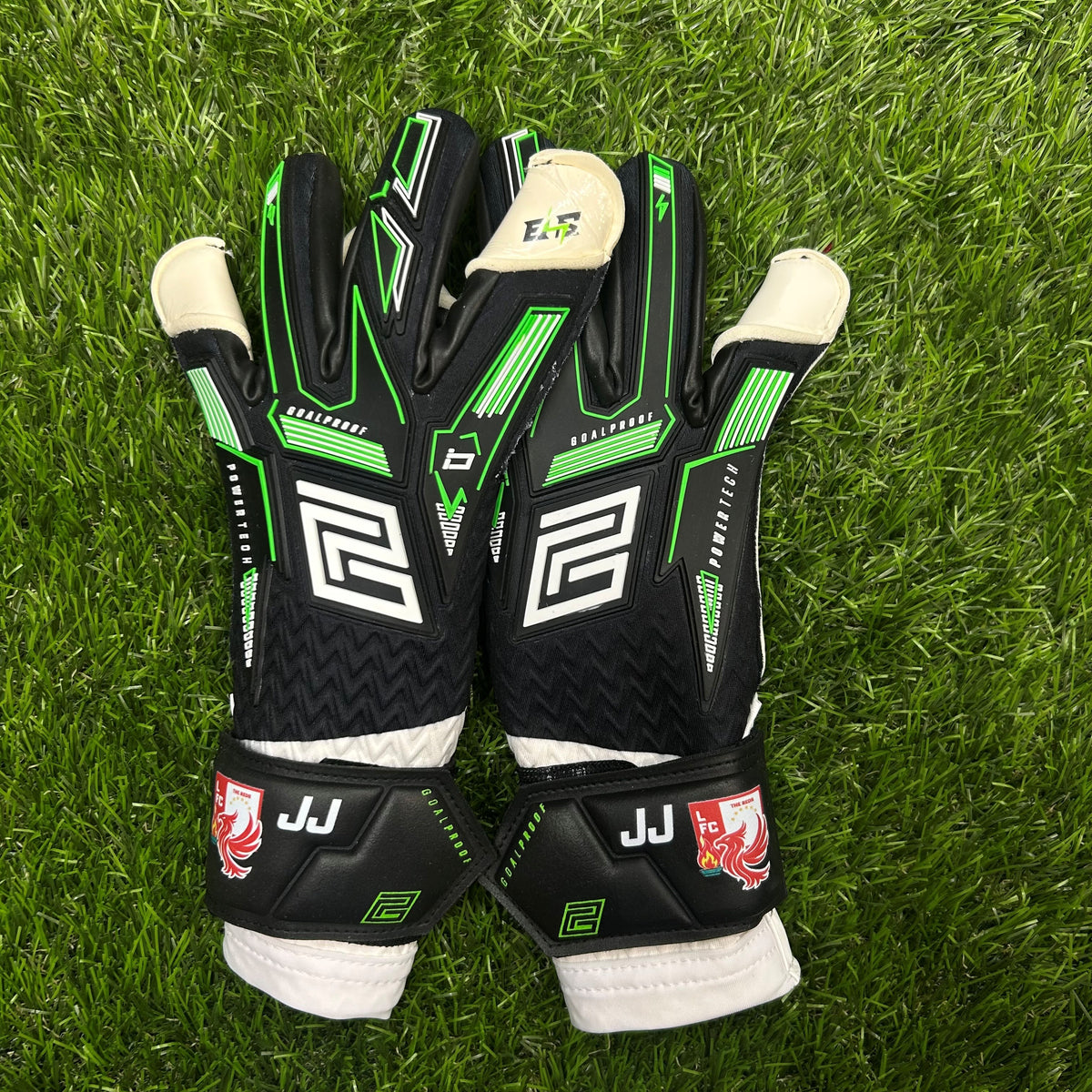 Keeper iD Electric Surge V-Wrap RS junior goalkeeper gloves in Black and Volt Green, personalised with initials and a flag on the wrist strap